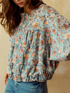Women's floral print cropped denim jacket with zip-up front and utility design, made from cotton blend fabric by Trendsi.
