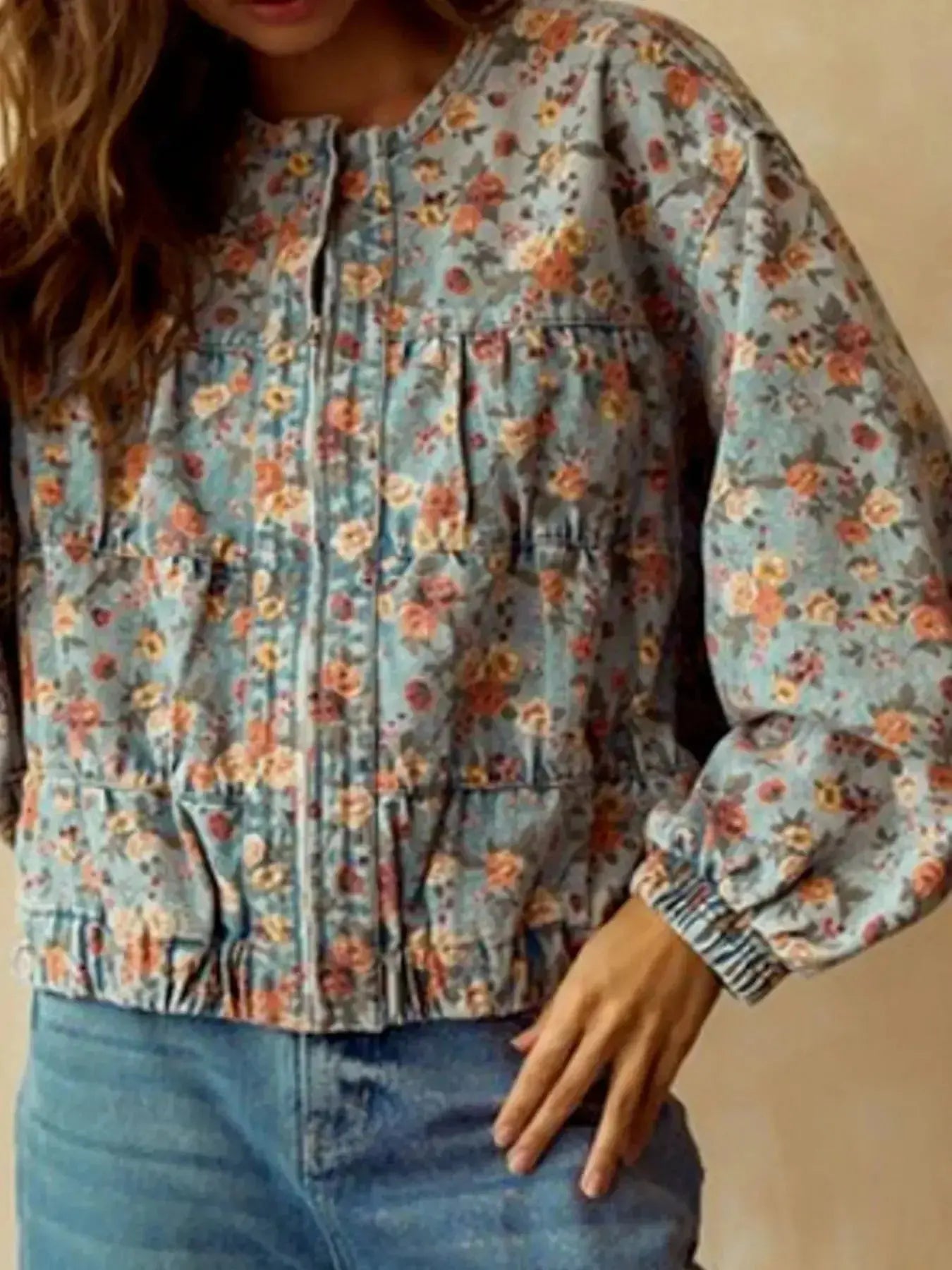 Women's floral print cropped denim jacket with zip-up front and utility style, made from cotton blend fabric.