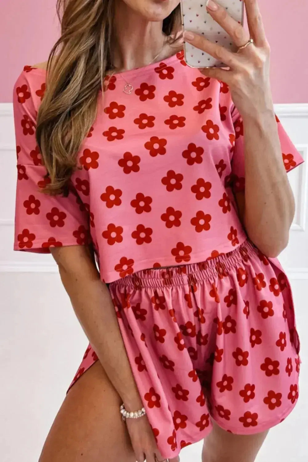 Women's floral print cropped pajama tee and shorts lounge set by Trendsi, featuring a comfortable, lightweight fabric and vibrant floral design.