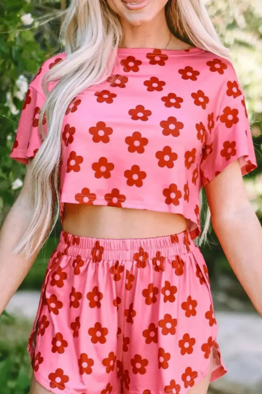 Women’s floral print cropped tee and shorts pajama lounge set by Trendsi, featuring a relaxed fit and vibrant floral pattern.