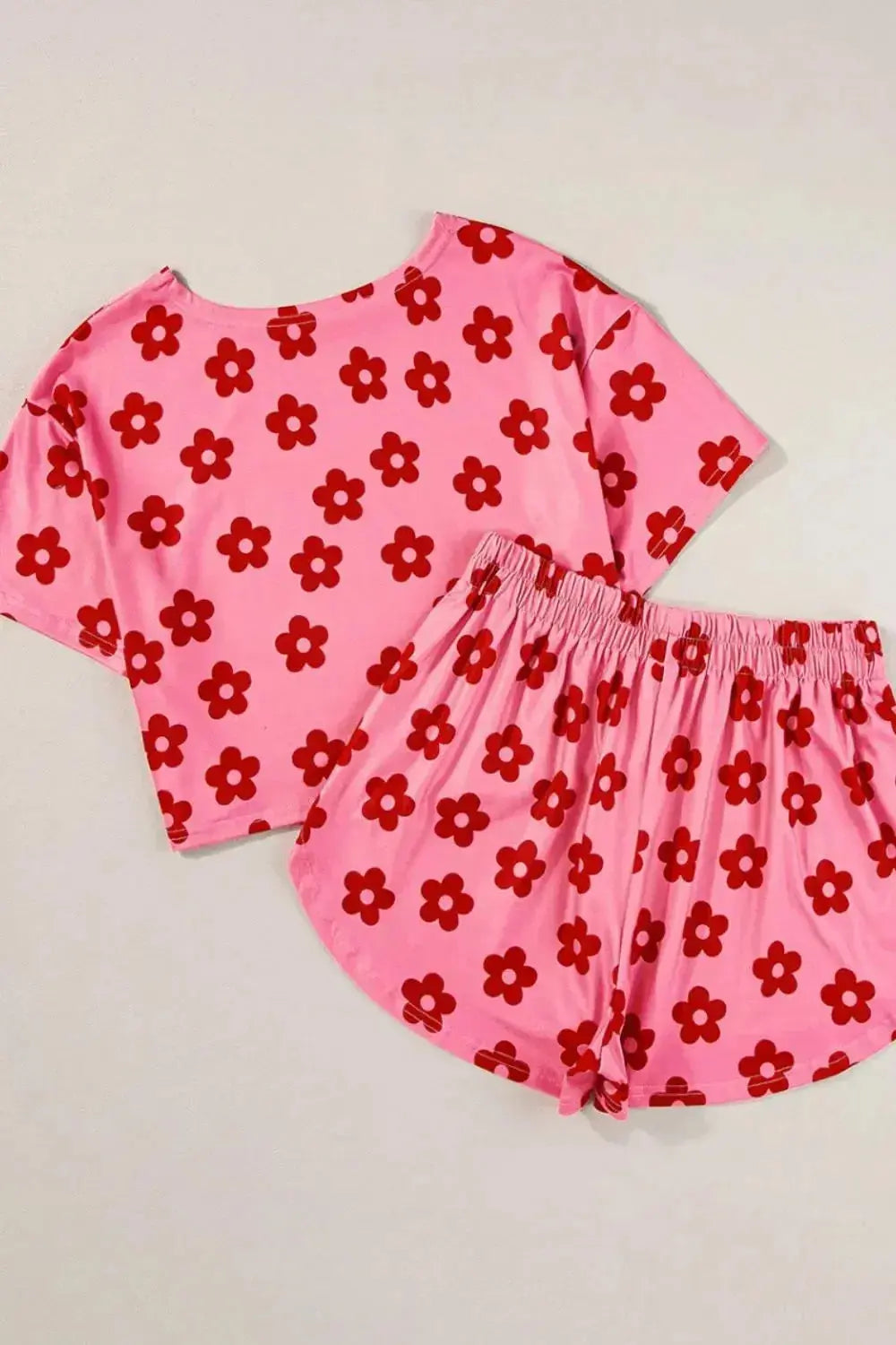 Women’s floral print cropped pajama tee and shorts lounge set by Trendsi, featuring a relaxed fit and vibrant floral design.