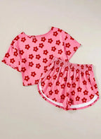 Women's floral print cropped tee and shorts pajama lounge set by Trendsi, featuring a comfortable, stylish pajama ensemble.