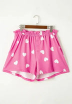 Women’s heart print long sleeve pajamas set with elastic waist shorts, featuring a cozy, comfortable design from Trendsi.