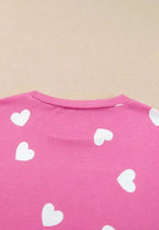 Women’s heart print long sleeve pajama set with elastic waist shorts from Trendsi, featuring a cozy, relaxed fit and playful design.