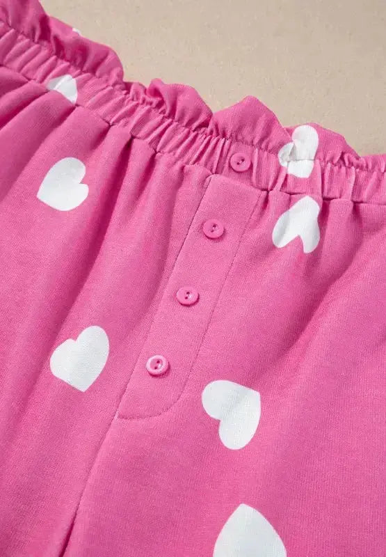 Women's heart print long sleeve pajama set with elastic waistband shorts, featuring a cozy, stylish sleepwear design by Trendsi.