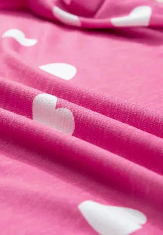 Women's heart print long sleeve pajamas set with elastic waist shorts from Trendsi, featuring a cozy, comfortable design.