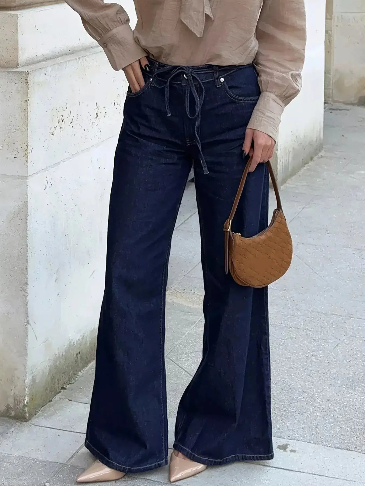 Women’s high-waisted flare jeans from Plush Fashion Hub, featuring a tied waist and relaxed fit in casual denim style.
