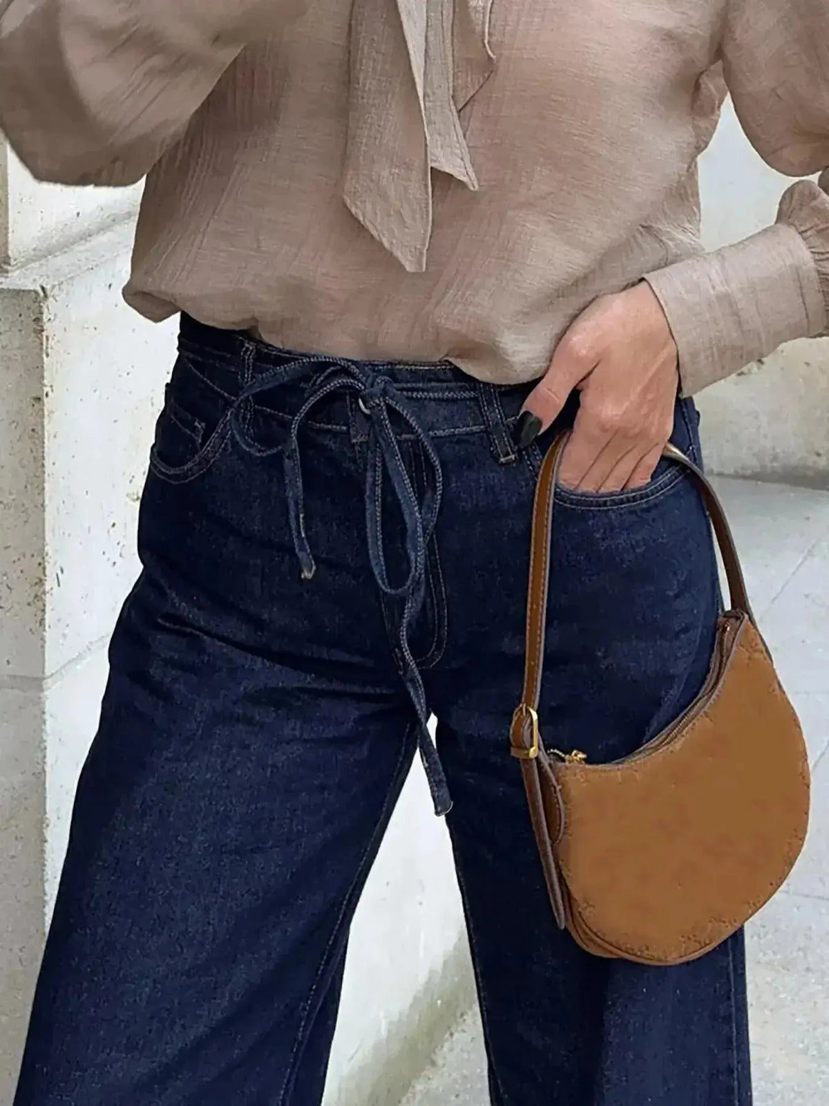 Women’s high-waisted tied loose fit flare jeans by Plush Fashion Hub, relaxed denim with a trendy flare silhouette.