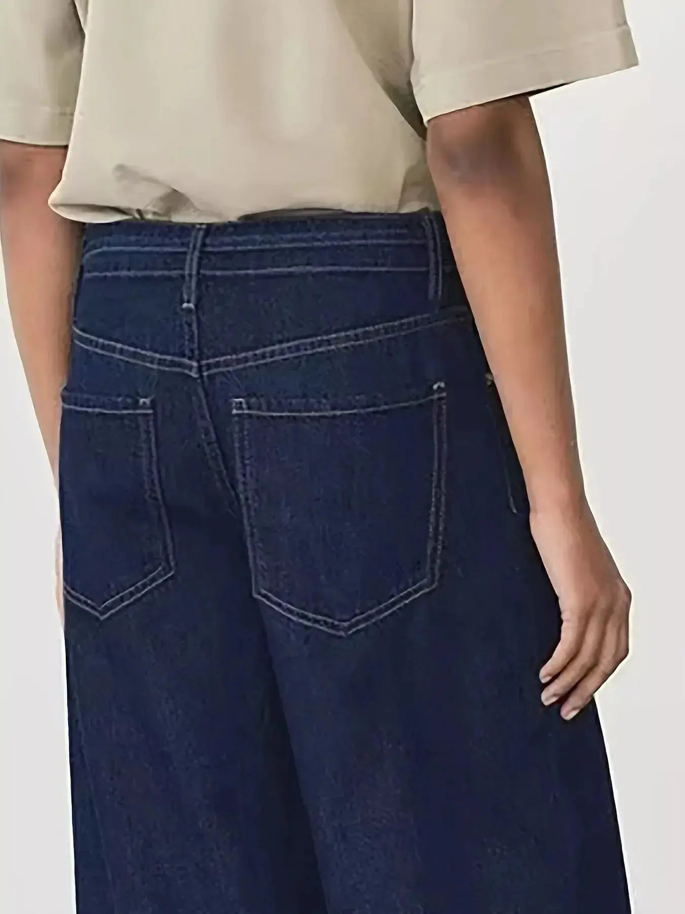 Women’s high-waisted tied loose fit flare jeans in relaxed denim, featuring a stylish silhouette and casual comfort.