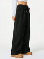 Women’s high-waisted wide-leg lounge pants with drawstring waist from Trendsi, perfect for comfortable casual wear.
