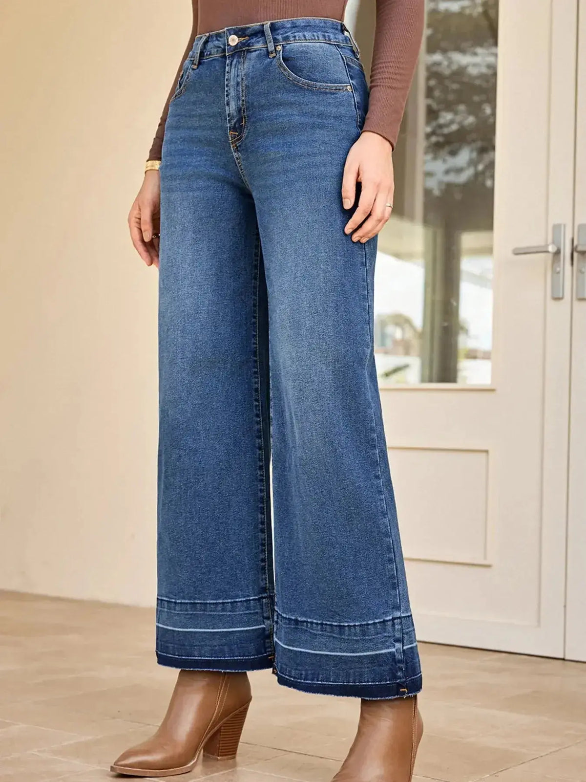 Women’s high-waisted wide-leg washed denim jeans with a classic relaxed fit, featuring faded denim and belt loops.