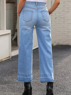 Women's high-waisted wide-leg washed denim jeans with a relaxed fit, styled casually, by Trendsi.