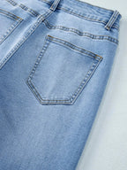 Women’s high-waisted wide-leg washed denim jeans with a relaxed fit, shown on a model in a casual pose.