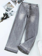 Women’s high-waisted wide-leg washed denim jeans with a relaxed fit, styled casually, by Trendsi.