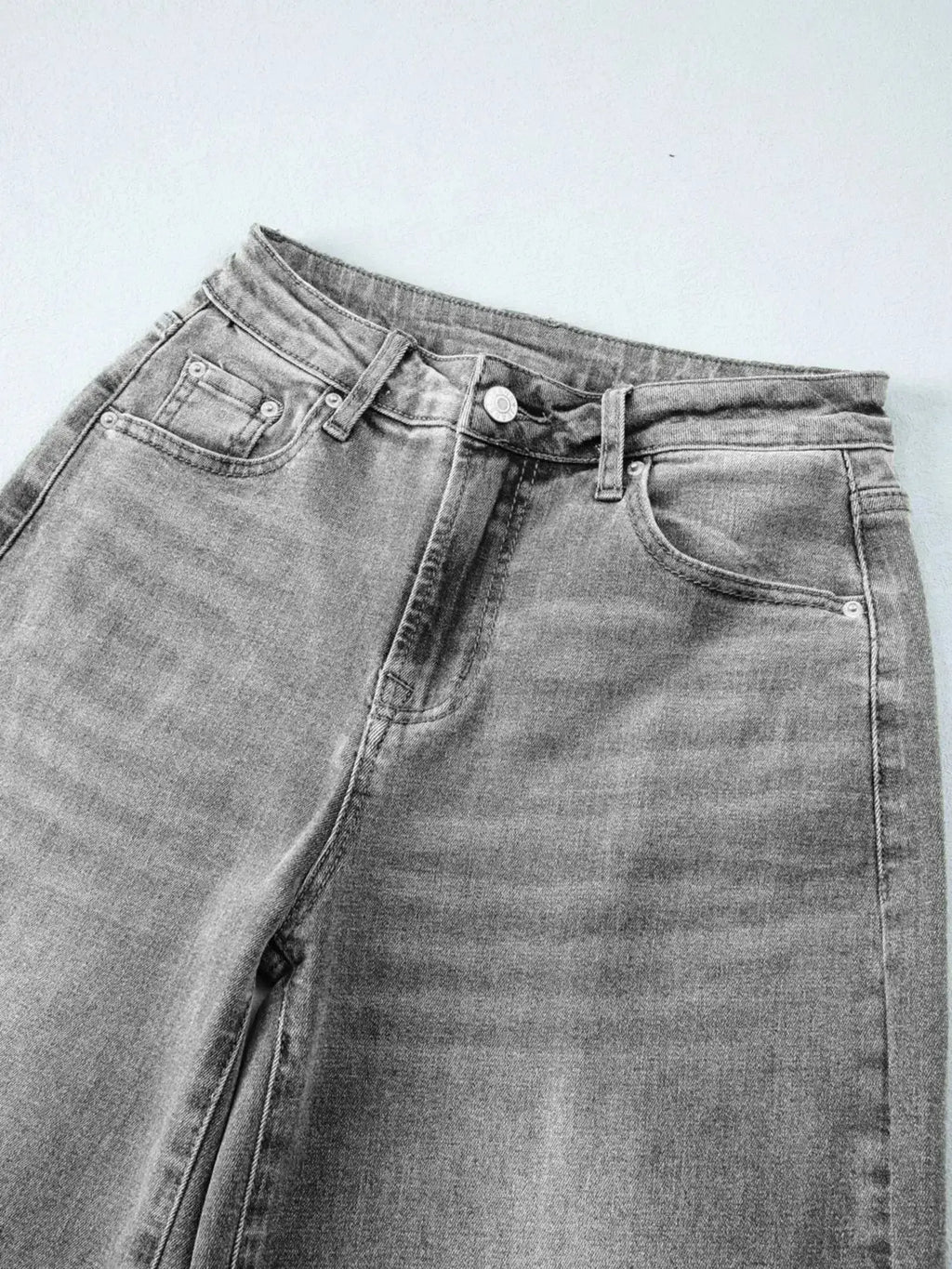 Women’s high-waisted wide-leg washed denim jeans with a relaxed fit, shown on a model, featuring classic denim styling by Trendsi.