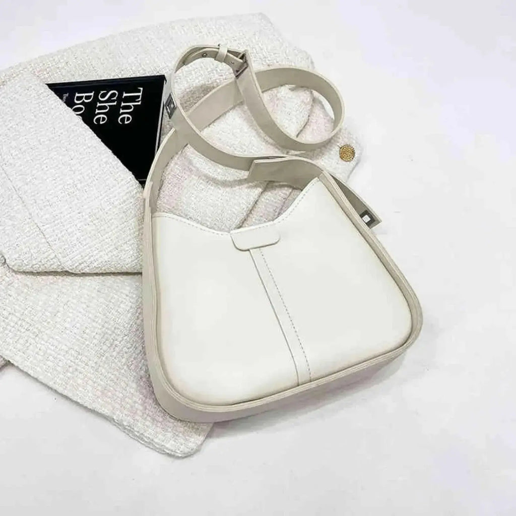 Women's textured vegan leather crossbody handbag with versatile shoulder strap from Plush Fashion Hub, showcasing high-end style and craftsmanship.