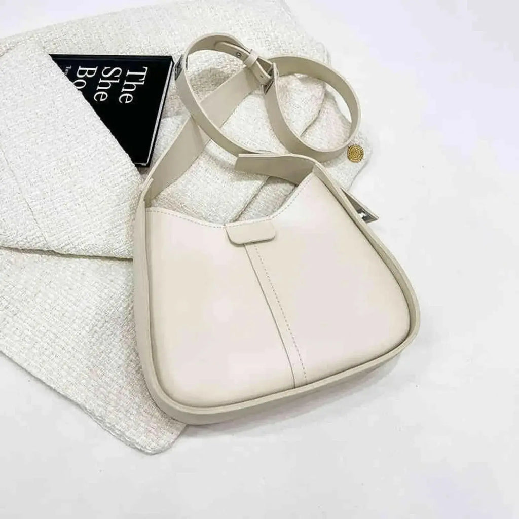 Women's textured vegan leather crossbody handbag with a sleek shoulder strap, versatile style from Plush Fashion Hub.