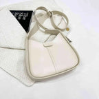 Women's textured vegan leather crossbody handbag with a sleek shoulder strap, versatile style from Plush Fashion Hub.