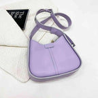 Women's textured vegan leather crossbody handbag with a versatile shoulder strap, featuring high-end style and plush finish.