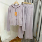Women's hooded sweatshirt and wide-leg pants lounge set by Plush Fashion Hub, featuring a cozy, stylish sweatsuit design.