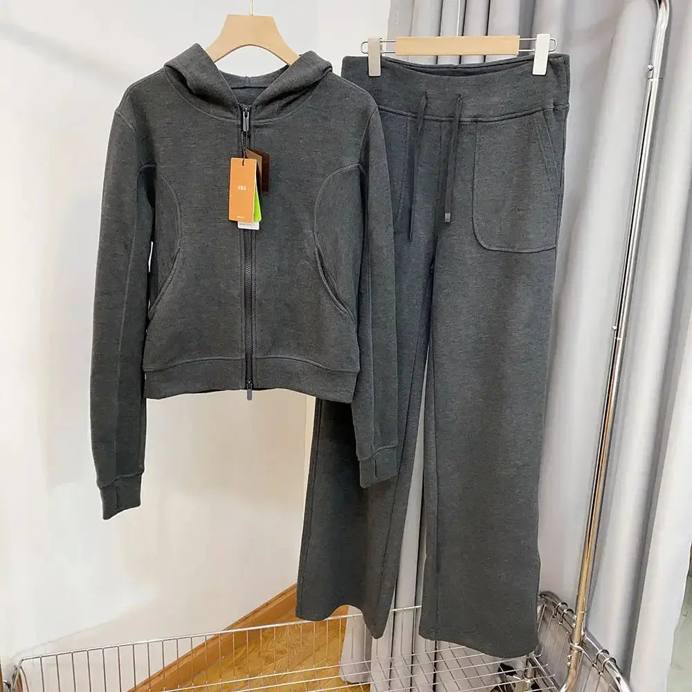 Women wearing Plush Fashion Hub hooded sweatshirt and wide-leg pants lounge set, showcasing comfortable, stylish sweatsuits.