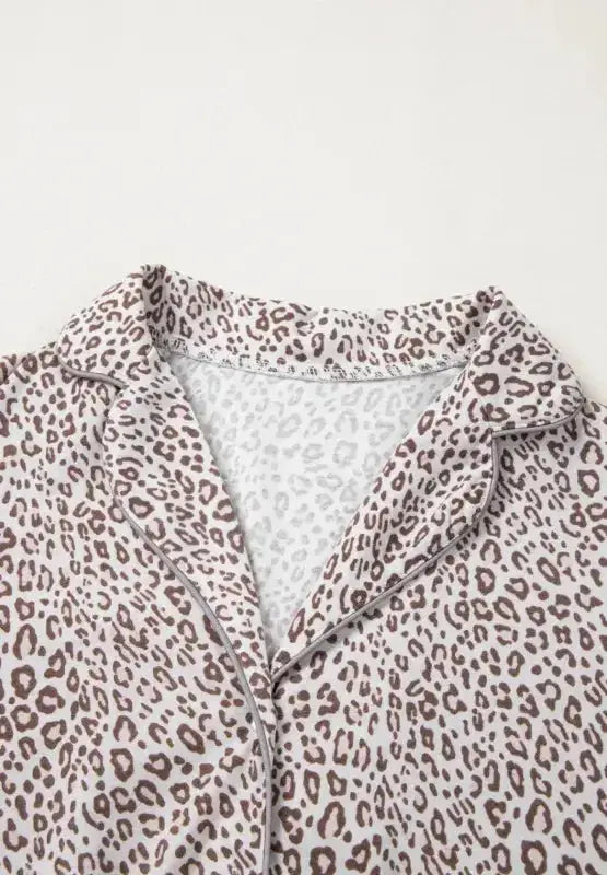 Women's leopard print long sleeve pajama lounge set by Trendsi, featuring a button-down top and comfortable matching pants.