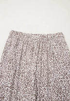 Women's leopard print button-down long sleeve pajama lounge set by Trendsi, featuring a stylish and comfortable pajama top and bottoms.