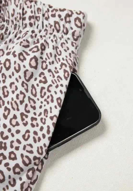 Women's leopard print pajama lounge set with button-down long sleeves, comfortable and stylish sleepwear from Trendsi.