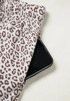 Women's leopard print pajama lounge set with button-down long sleeves, comfortable and stylish sleepwear from Trendsi.