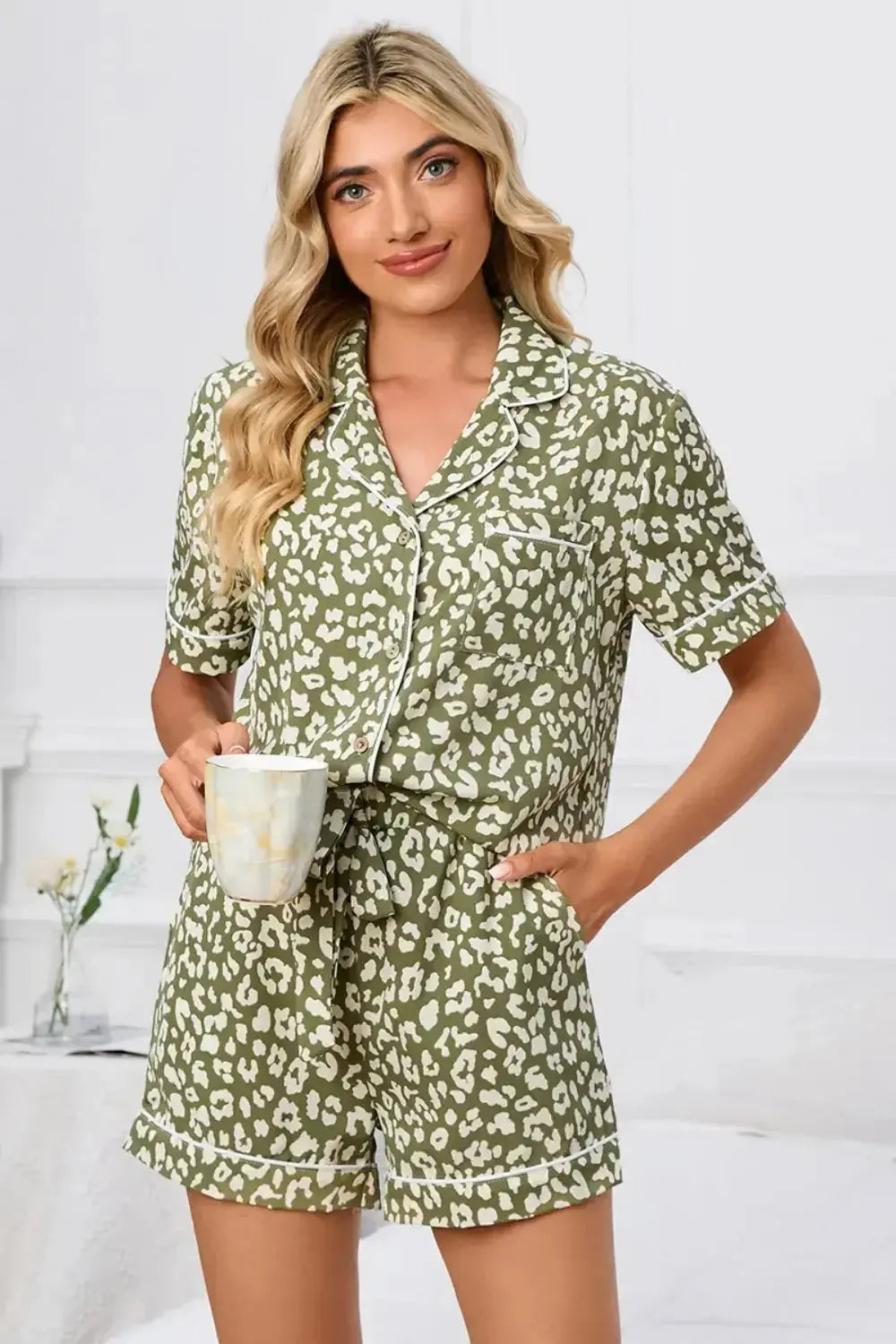Women's leopard print button-down short sleeve pajama lounge set by Trendsi, featuring a comfortable and stylish pajama top and shorts.