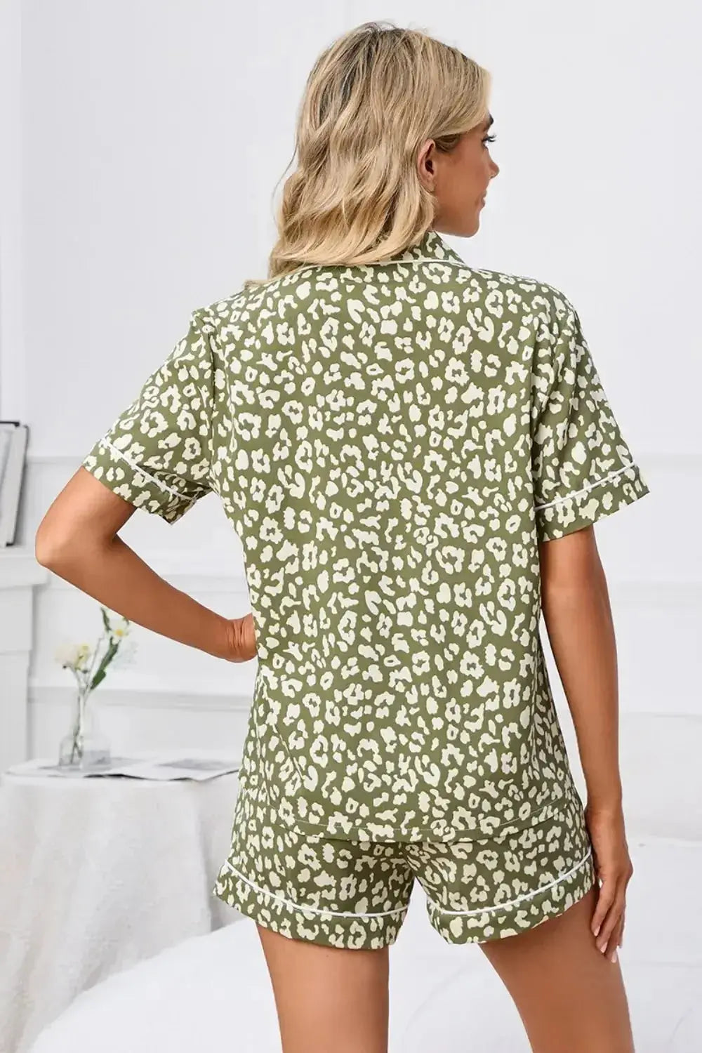 Women’s leopard print short sleeve pajama lounge set by Trendsi, featuring a button-down top and matching shorts.