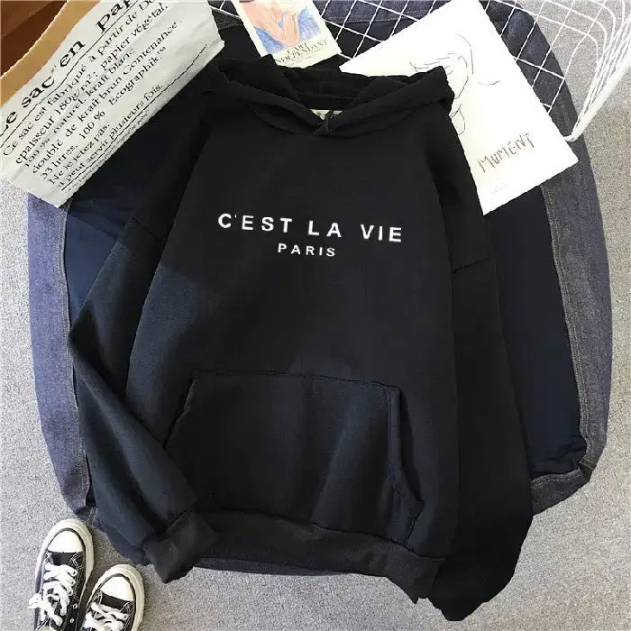 Women wearing a plush fashion hub oversized graphic letter print hoodie, cozy streetwear style, in a casual urban setting.