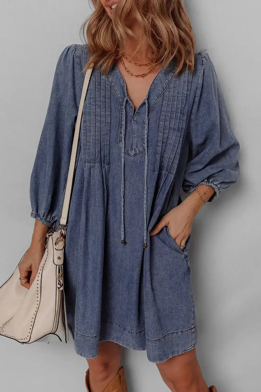 Women's long sleeve denim mini dress with tie neck, soft cotton material, casual style, by Trendsi.