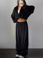 Women’s plush long sleeve zip-up jacket and matching pants lounge set by Trendsi, cozy and stylish for relaxed wear.