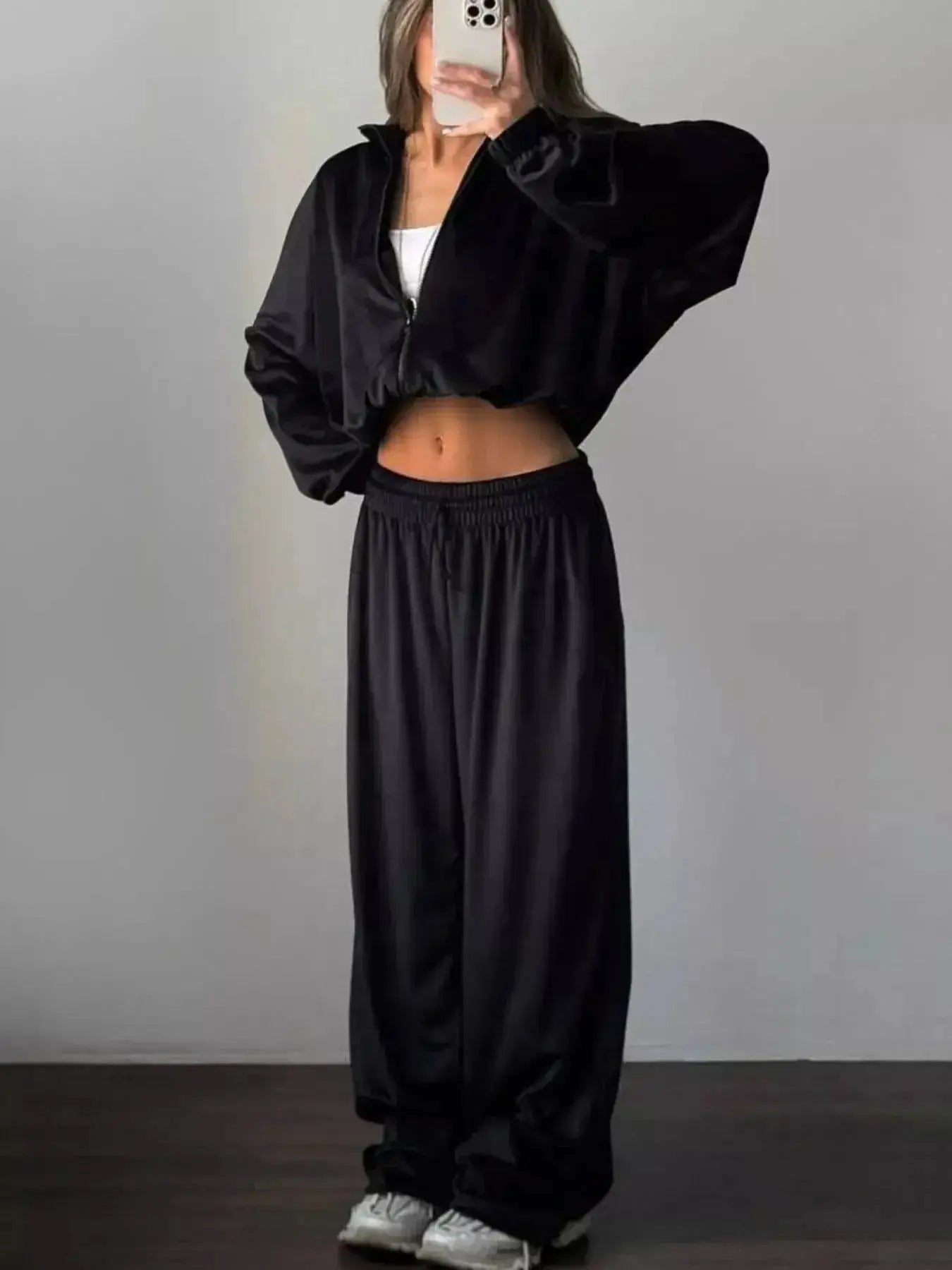 Women’s plush long sleeve zip-up jacket and matching pants lounge set by Trendsi, cozy and stylish for relaxed wear.