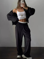 Women's long sleeve zip-up jacket and pants lounge set by Trendsi, plush fabric, comfortable casual wear ensemble.