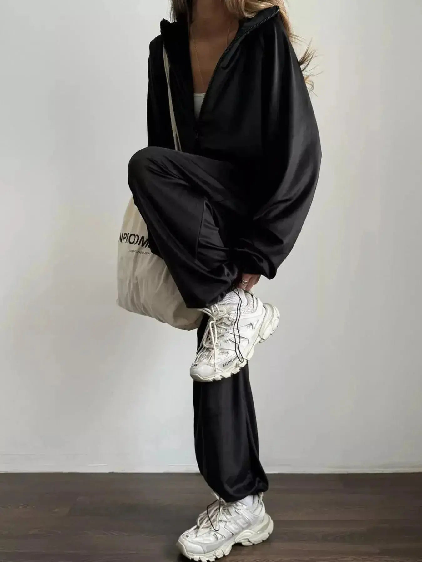 Women's long sleeve zip-up jacket and pants lounge set by Trendsi, plush fabric, casual comfy loungewear ensemble.