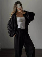 Women’s long sleeve zip-up jacket and pants lounge set by Trendsi, plush fabric, comfortable loungewear for relaxed style.