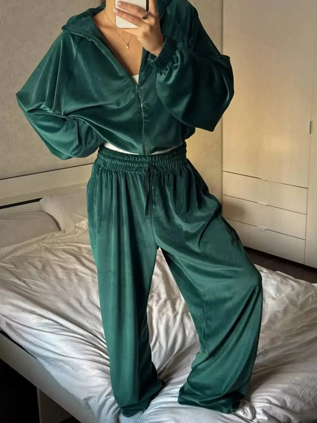 Women’s long sleeve zip-up jacket and pants lounge set by Trendsi, plush cozy fabric, stylish and comfortable for casual wear.
