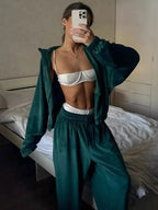 Women’s long sleeve zip-up jacket and matching lounge pants set by Trendsi, plush fabric, cozy and stylish for relaxed wear.