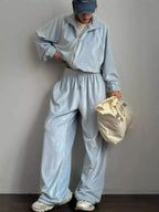 Women's long sleeve zip-up jacket and pants lounge set by Trendsi, plush fabric, comfortable casual wear, stylish loungewear ensemble.