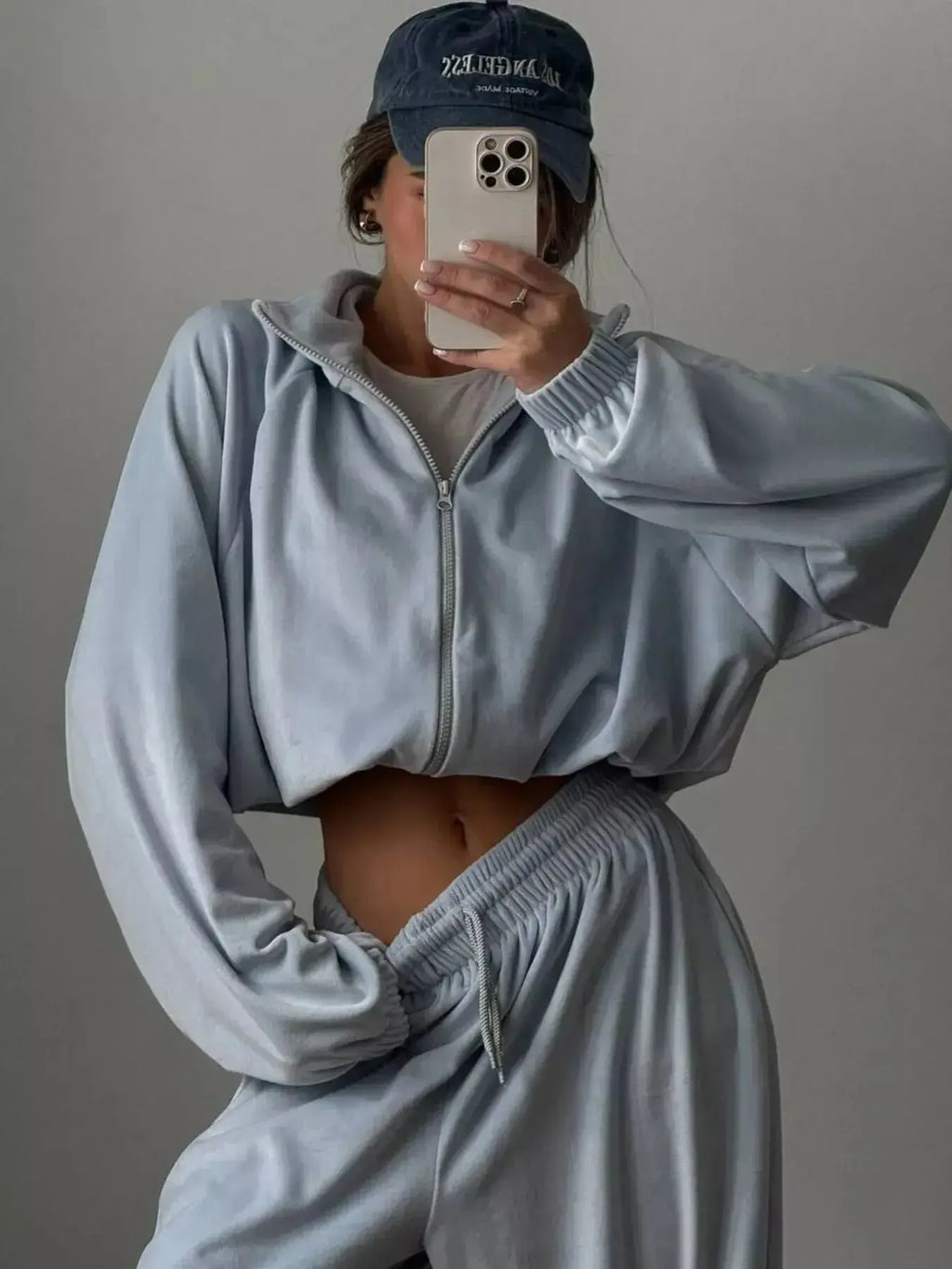 Women’s long sleeve zip-up jacket and matching lounge pants set by Trendsi, plush fabric, casual comfortable loungewear.