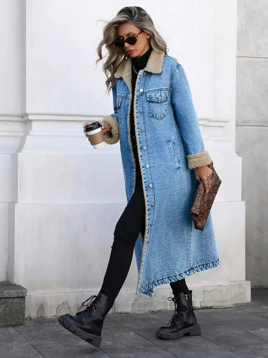Women’s longline denim jacket with sherpa lining, cozy fall and winter outerwear by Trendsi featuring button closure and side pockets.