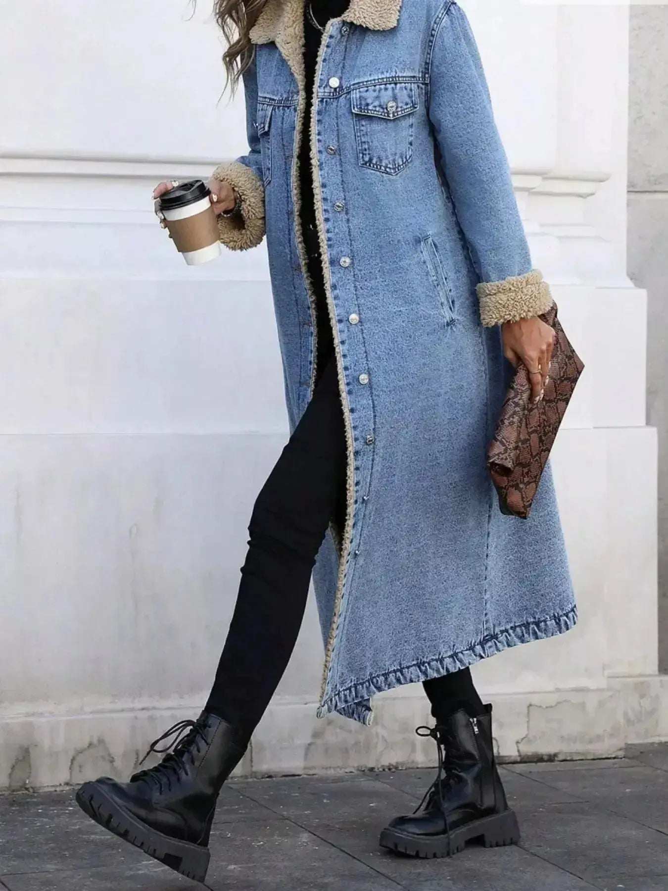 Women's longline denim jacket with cozy sherpa lining, perfect for fall and winter outerwear by Trendsi.