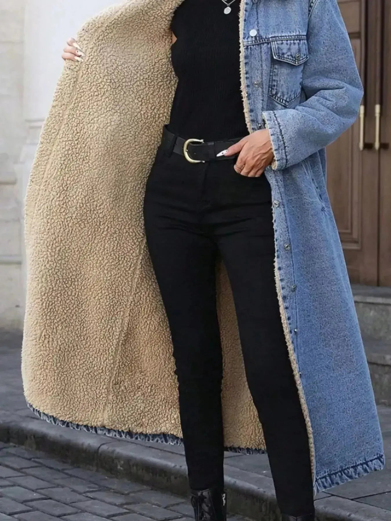 Women’s longline denim jacket with sherpa lining, cozy fall and winter outerwear by Trendsi, featuring classic denim style and warm interior.