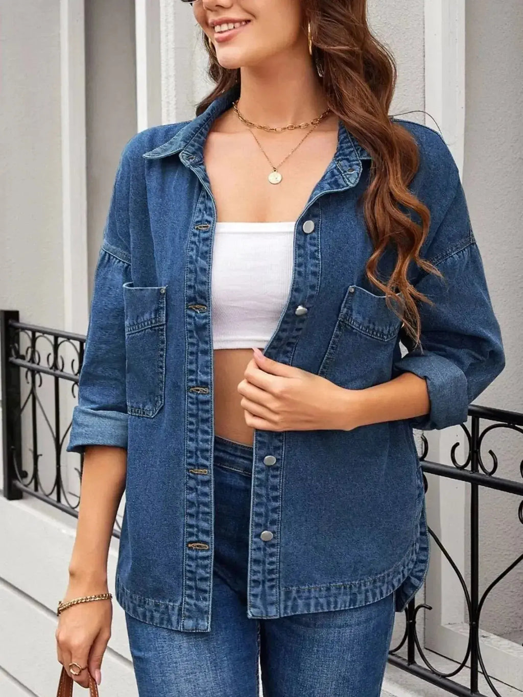 Women’s oversized denim jacket with button-up front, relaxed fit, casual outerwear by Trendsi, shown on a model.