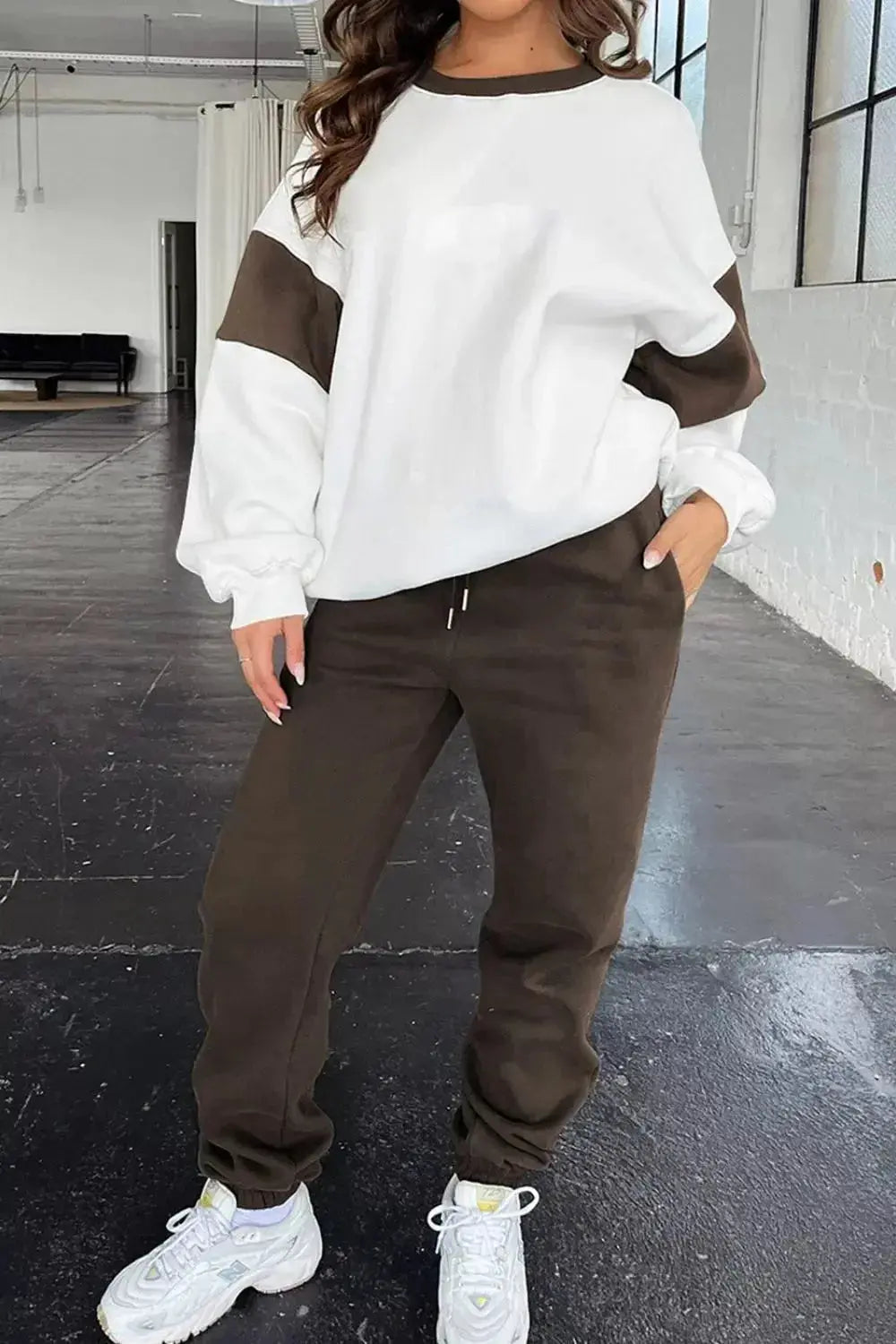 Women's oversized drop shoulder sweatshirt and joggers loungewear set by Trendsi, featuring comfortable, casual jogger suit for relaxed wear.