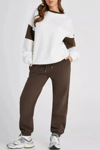 Women’s oversized drop shoulder sweatshirt and matching joggers loungewear set by Trendsi, comfortable casual jog suit for relaxed wear.