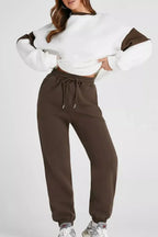 Women wearing an oversized drop shoulder sweatshirt and matching joggers loungewear set from Trendsi, casual and comfortable outfit.