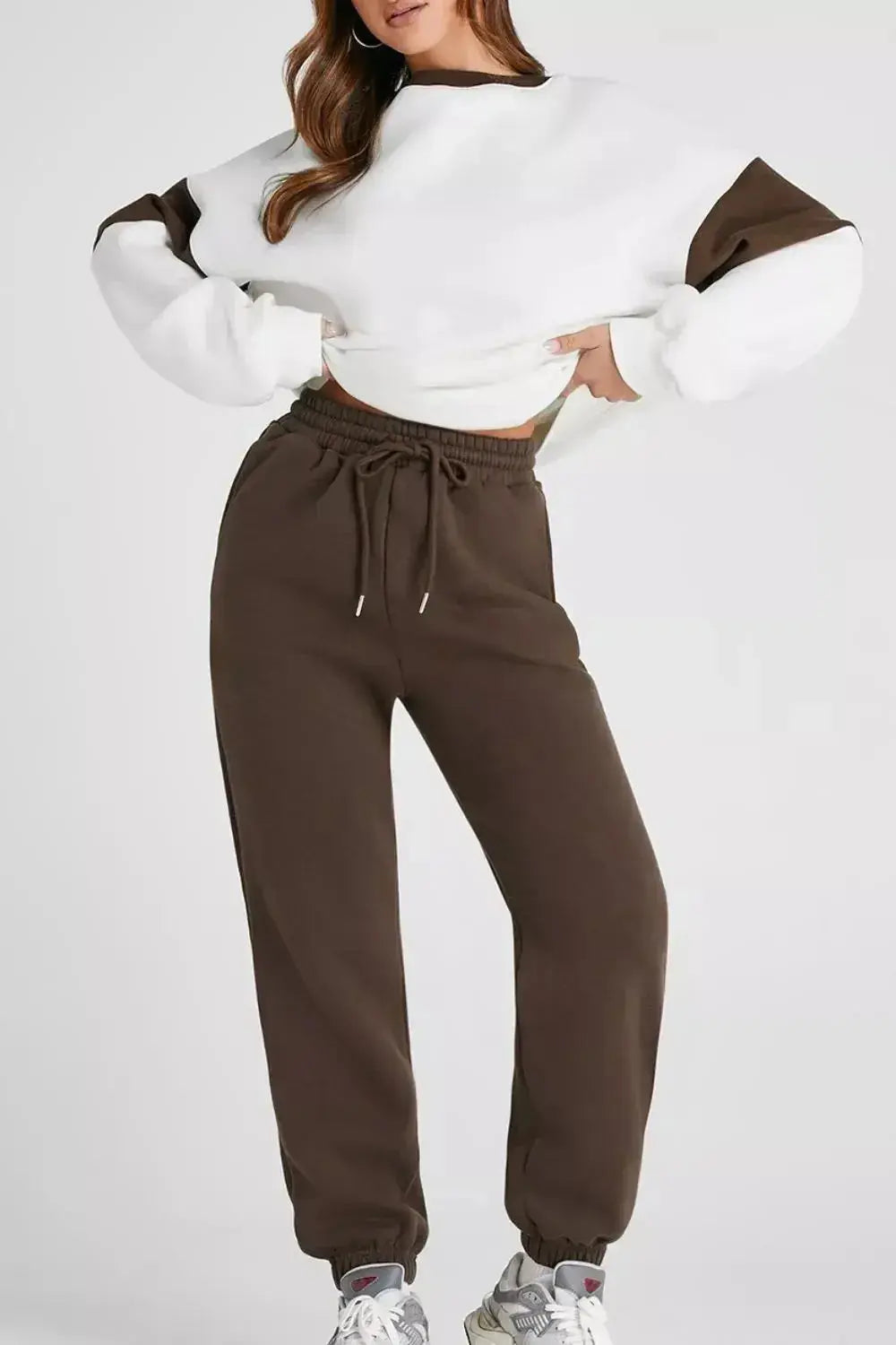 Women wearing an oversized drop shoulder sweatshirt and matching joggers loungewear set from Trendsi, casual and comfortable outfit.